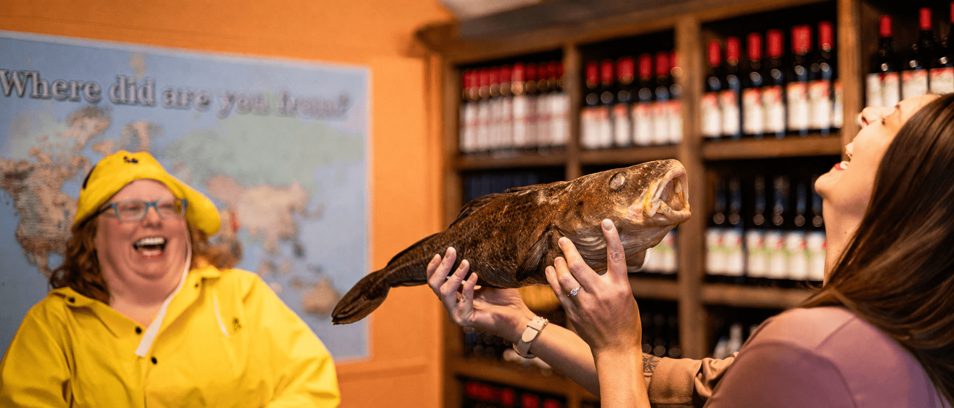 Guest taking part in a screech-in cod-kissing moment at Great Auk Winery